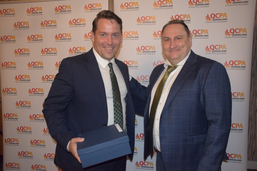 Drew Creighton, The Ipswich Tribune accepts award from Lukas White, Potent